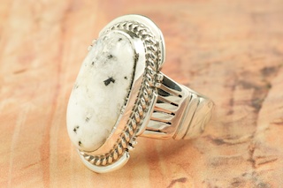 White Buffalo Turquoise set in Sterling Silver Ring. This Beautiful Stone is formed from the minerals Calcite and Iron. It is mined near Tonopah Nevada. Created by Navajo Artist John Nelson. Signed. 